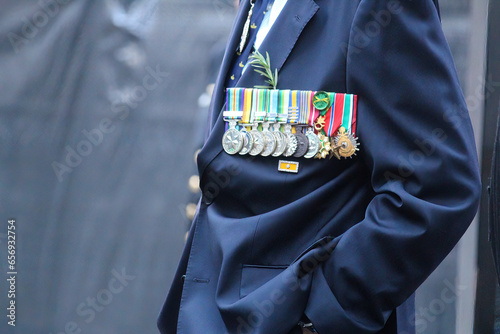 Sydney, NSW Australia - April 25 2021: Anzac Day March. A man in a blue suit wearing medals and rosemary