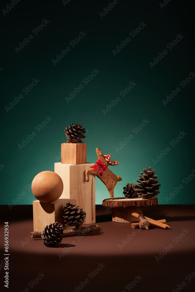 Wooden podiums displayed with some pine cones, cinnamon sticks and a reindeer cake. Blank space on brown surface for goods or product presentation