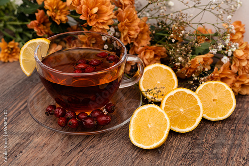 Rosehip tea with lemon in a clear cup. Autumn drink for colds