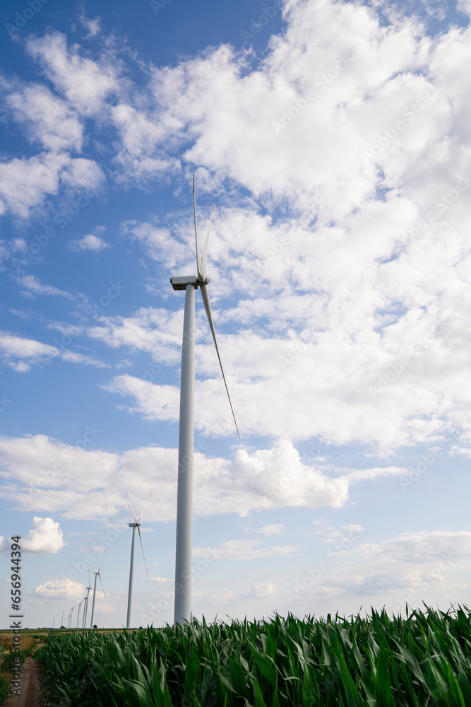 Wind turbines under cloudy sky at field Wind turbines under cloudy sky at field