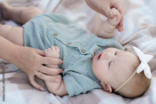 Closeup newborn baby's hand holding a mother's finger.