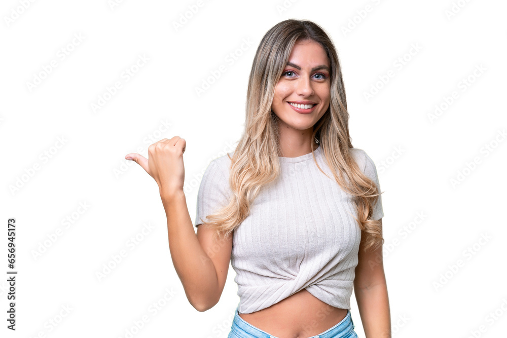 Young Uruguayan woman over isolated background pointing to the side to present a product Young Uruguayan woman over isolated background pointing to the side to present a product