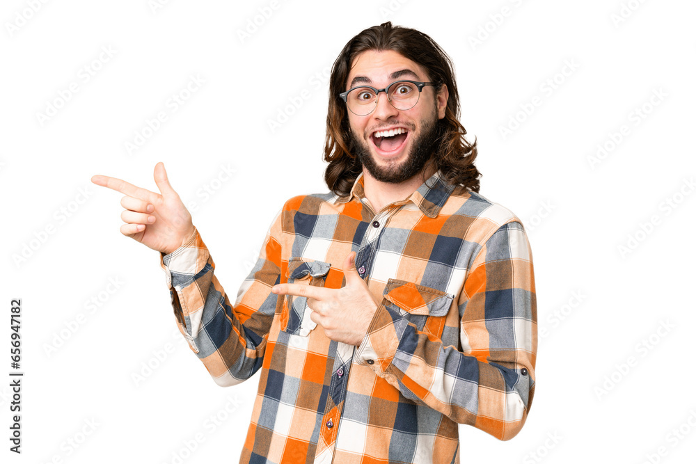 Young handsome man over isolated chroma key background surprised and pointing side Young handsome man over isolated chroma key background surprised and pointing side