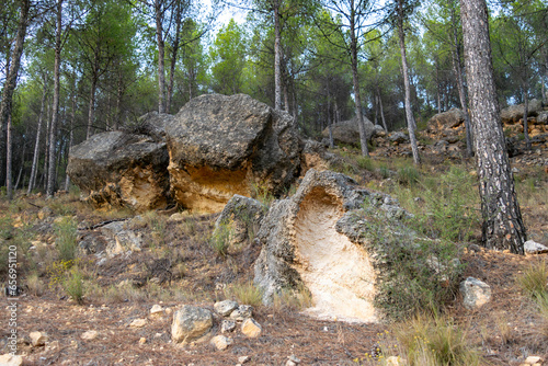 View of some rocks, one of them of sedimentary and sandy type eroded by the environment in the forests of Rincón de Ademuz in the Iberian Peninsula