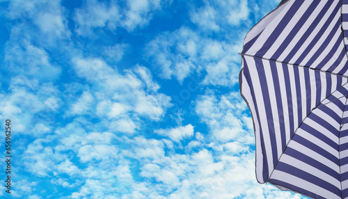 Fototapeta Naklejka Na Ścianę i Meble -  Umbrella on a tropical beach under sky cloud background
