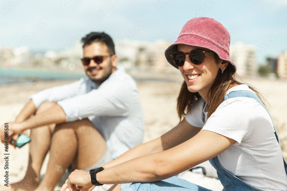 Smiling couple sitting on beach Smiling couple sitting on beach