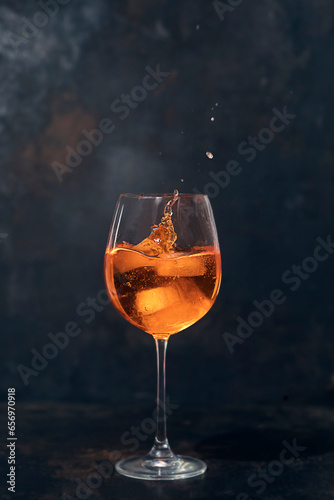 Glass of Aperol spritz with ice cubes photo
