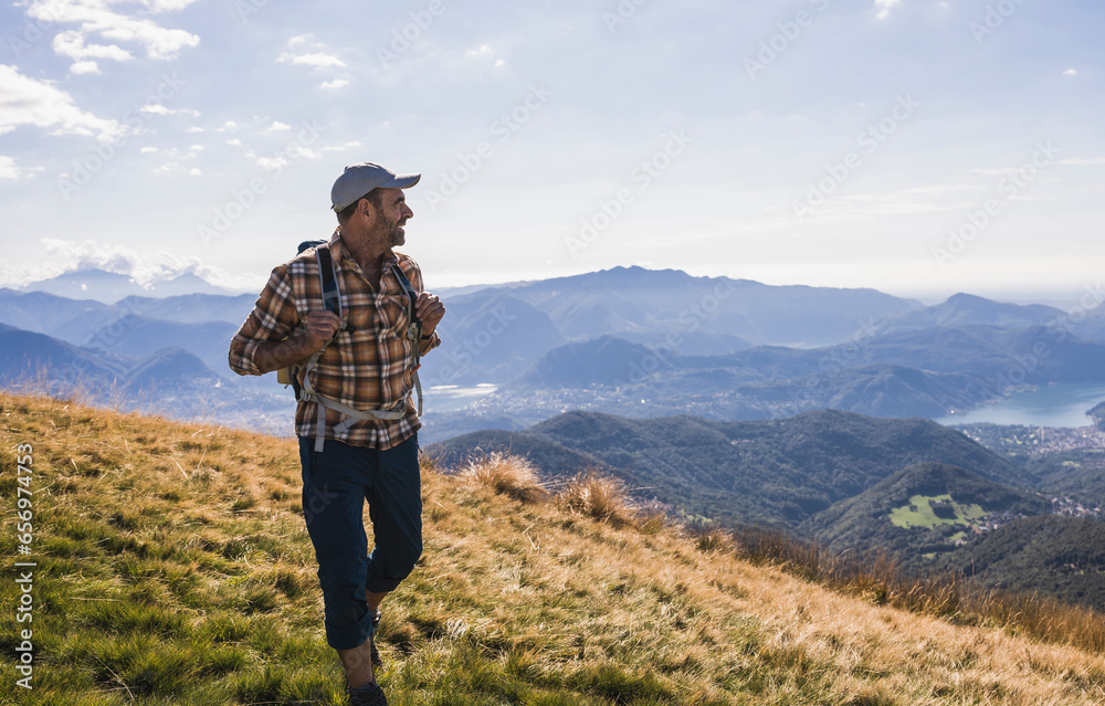 Mature hiker exploring nature walking on mountain Mature hiker exploring nature walking on mountain