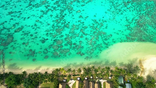 Cinematic slow motion top down drone video of luxury art villas on the coast of Rarotonga photo