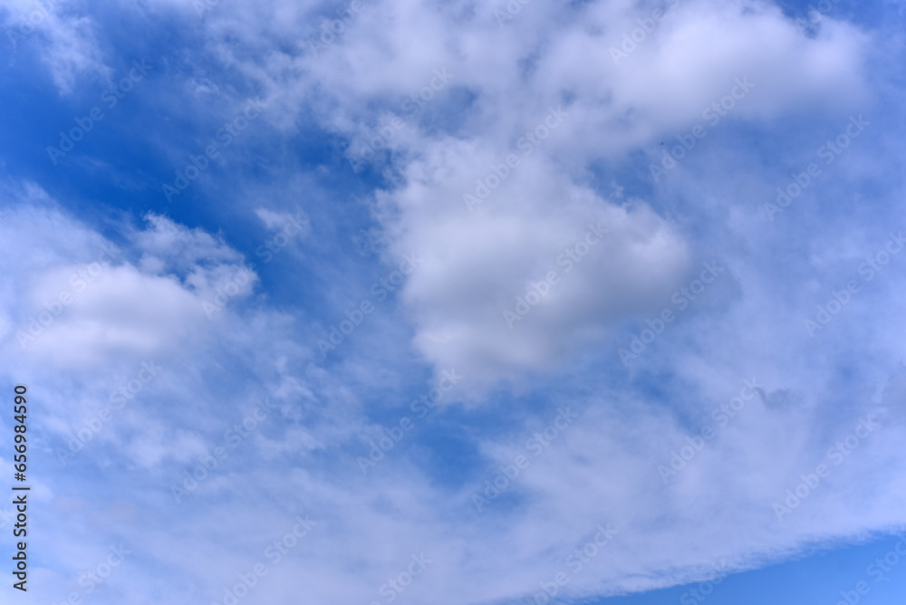 White clouds on a blue sky. Clusters of white clouds of various shapes. round and soft white clouds White clouds on a blue sky. Clusters of white clouds of various shapes. round and soft white clouds