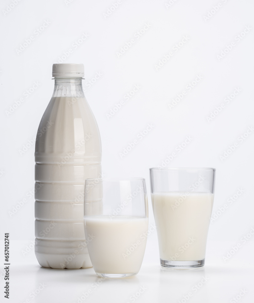 fresh milk in plastic bottle with glass glasses on white background fresh milk in plastic bottle with glass glasses on white background