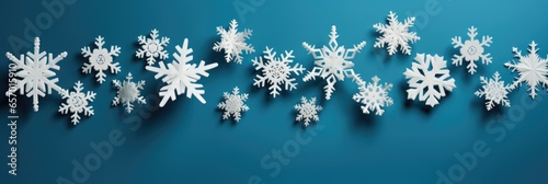 Paper snowflake decorations on a calming blue background