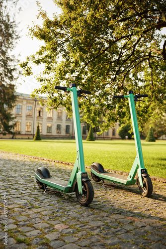 Eco-friendly electric scooter vehicles parked at university campus