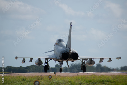 raf military typhoon aircraft ready to take off, heat distortion lining up with landing lights airshow display team formation 