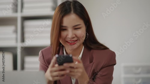 Businesswoman in brown suit is using smartphone for relax on social media and messaging with friends. photo