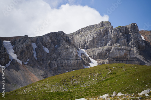 Breathtaking views of the mountain range surrounded by alpine meadows.