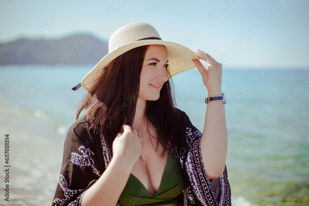A girl in a hat on the background of the sea