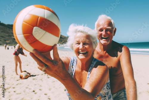 An elderly couple playing volleyball on the beach