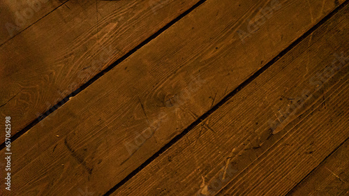 Vintage floor of textured wooden board as background closeup. Country house ground covered with natural timber material. Old lamber planks used for traditional building and flooring works photo