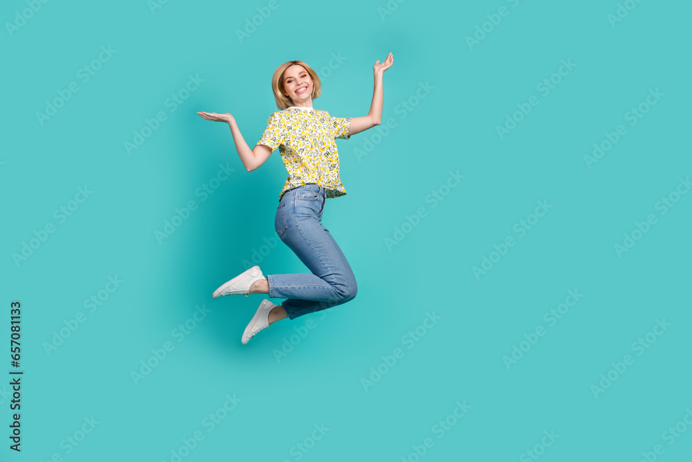 Full length photo of impressed shocked lady wear flower print t-shirt jumping high empty space isolated turquoise color background
