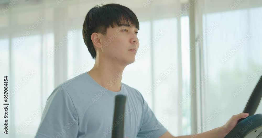 Young asian men exercising and running on treadmill in sport gym. He enjoying to exercise at gym. Young asian men exercising and running on treadmill in sport gym. He enjoying to exercise at gym.