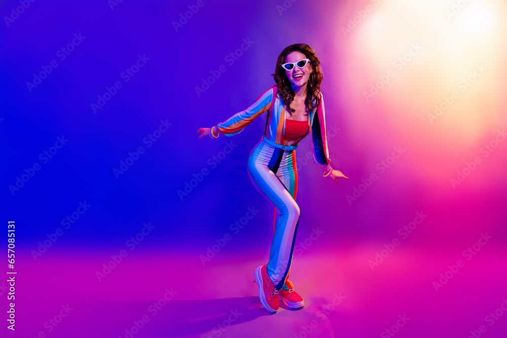 Full size portrait of positive gorgeous girl enjoy new year event dancing isolated on multicolor neon background