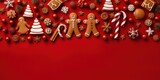 Red Christmas background with Season Composition Festive Elements such as Cookies, gift box, Candies, snowflake, gingerbread men, winter spice, Christmas Tree Decorations.