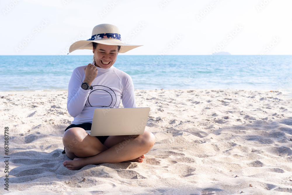 Work from anywhere, happy female with laptop on the beach.