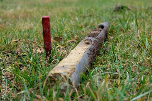 Geological core sample with drilled soil layers laying in the grass, side view, concept of soil quality and environmental research