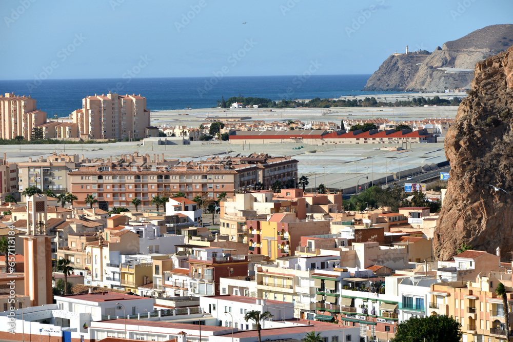 aerial view of city of Calahonda with beach and greenhouses with plastic covers at costa del sol in Andalucia