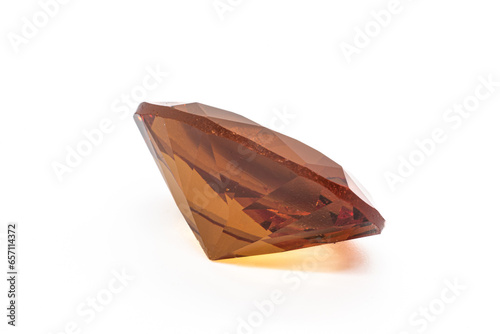 Colour changing diaspore, Turkish Zultanite oval faceted on white background under white artificial light. Yellow to orange color shift zultanite. photo
