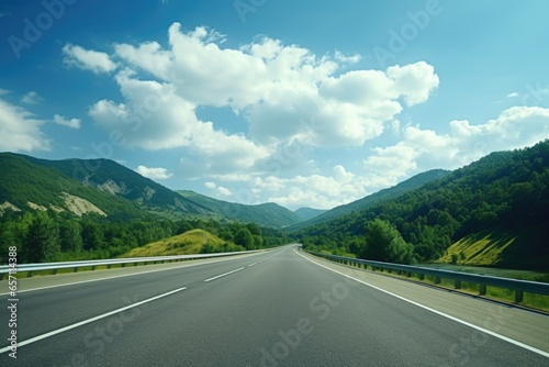 A picture of an empty highway with majestic mountains in the background. Perfect for travel and adventure themes.