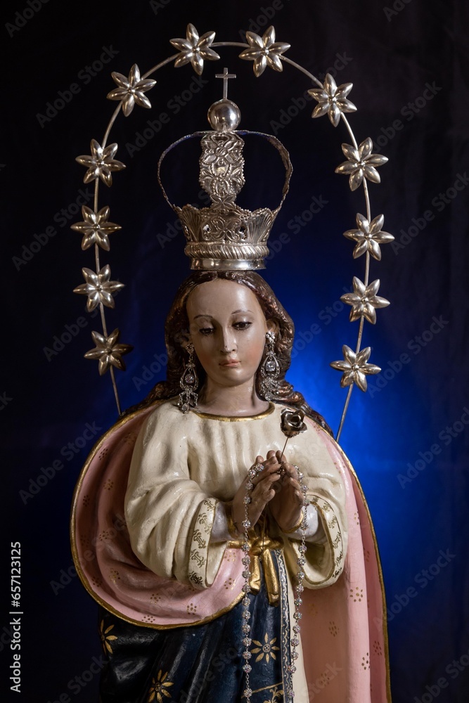 Statue of the Virgin of Fatima on an altar with dark background