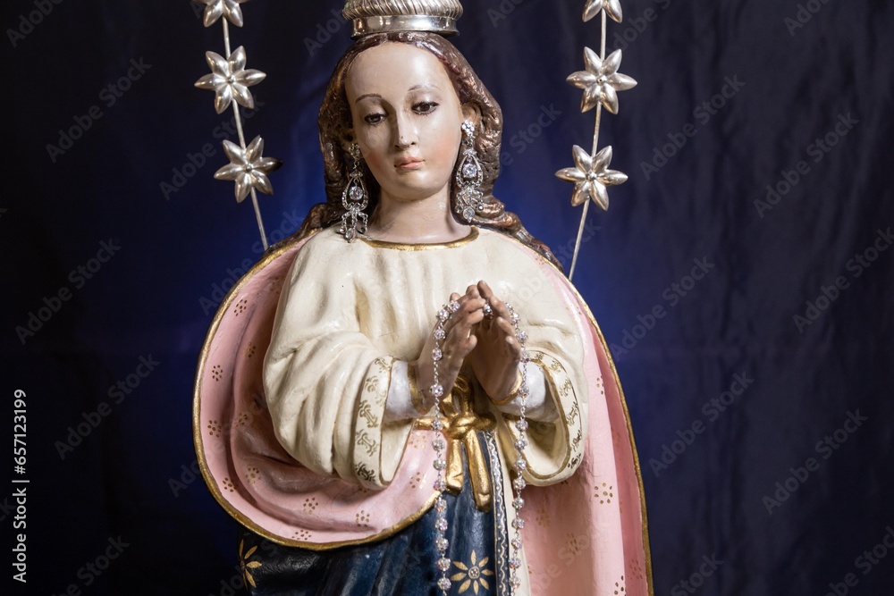 Statue of the Virgin of Fatima on an altar with dark background