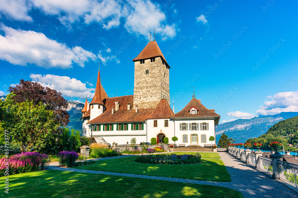 View of Spiez Church and Castle on the shore of Lake Thun in the Swiss canton of Bern at sunset, Spiez, Switzerland. Spiez Castle on lake Thun in the canton of Bern, Switzerland.