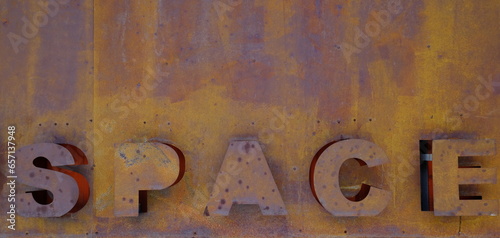 Embossed letters form the sowrd space on rusty surface photo