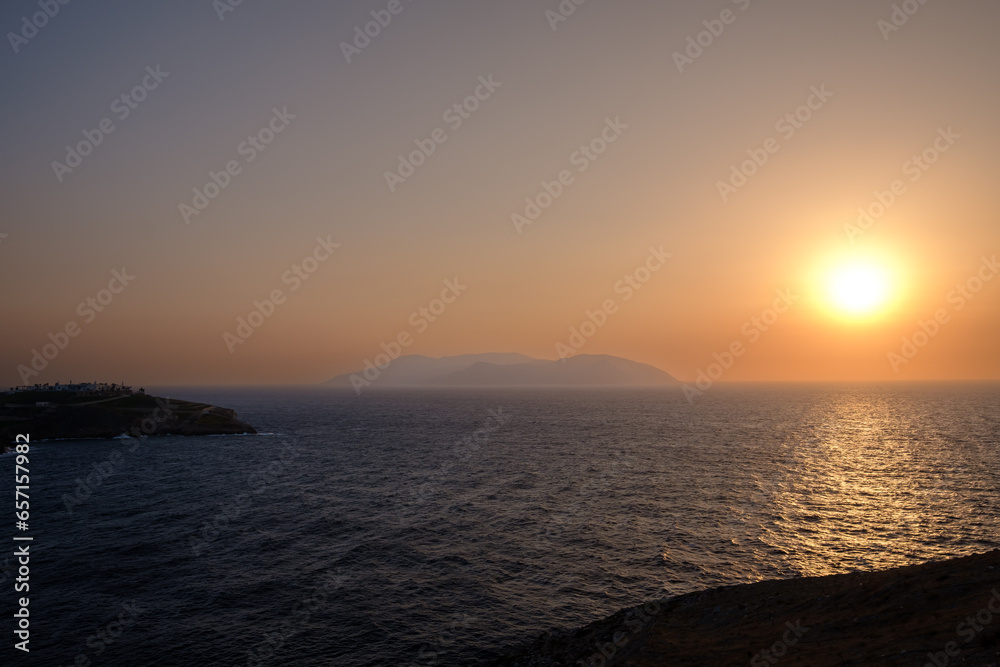 View of a swimming pool overlooking the Aegean Sea and a spectacular sunset in Ios Greece
