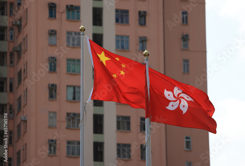 Chinese and hong kong flag set up in the event for celebrating the National Day of the People's Republic of China 74 th anniversary with the real estate background