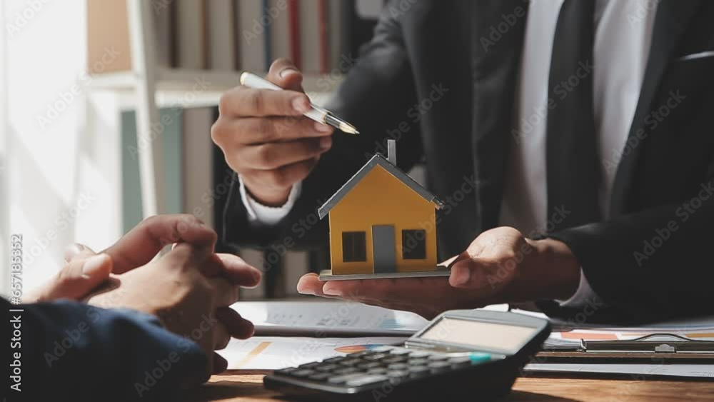 Real estate brokerage agent Deliver a sample of a model house to the customer, mortgage loan agreement Making lease and buy and sell house And contract home insurance mortgage loan concept