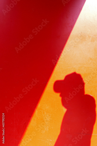 shadow of a man on the red painted wall