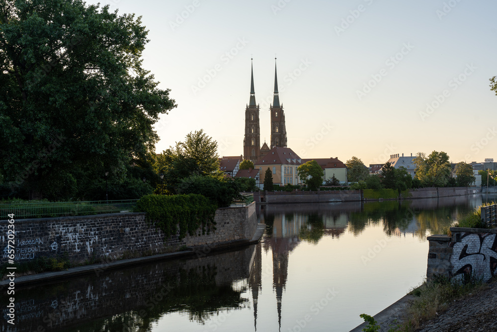 The church at dawn is reflected in the river