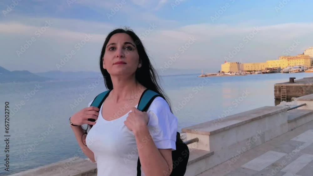 A tourist observes the view while walking along the Gaeta seafront A tourist observes the view while walking along the Gaeta seafront