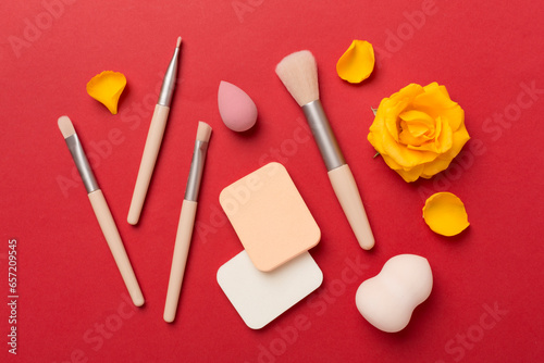 Makeup brushes and sponges on color background, top view © Liami