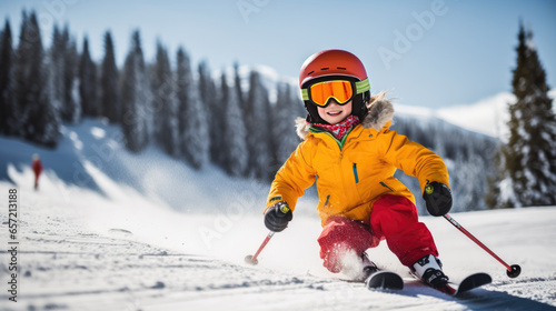 Fotografiet Kid Skier descends a mountain in winter