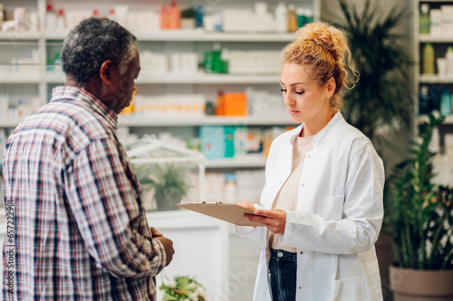 Woman pharmacist talking with a senior patient customer in a pharmacy