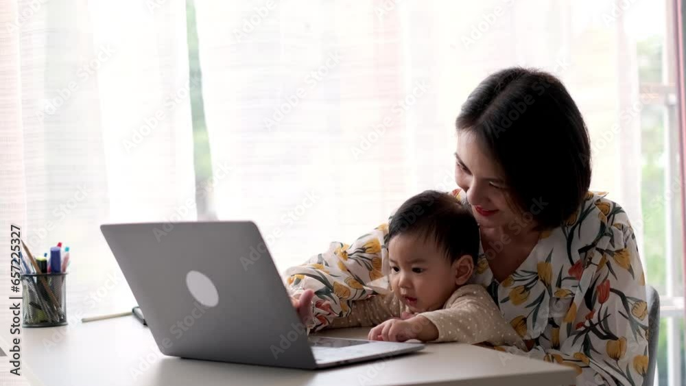 Happiness Asian mother working at home with toddler her son. Technology communication and lifestyle concept. Happiness Asian mother working at home with toddler her son. Technology communication and lifestyle concept.