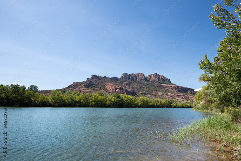 Rocher de Roquebrune and the Argent River in foreground with copy space, Roquebrune-sur-Argens, France, a tourist destination in Summer