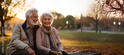 Fototapeta Naklejka Na Ścianę i Meble -  woman man senior couple happy retirement together elderly hug active bonding park outdoor sitting bench leisure fun smiling love old nature wife happiness mature