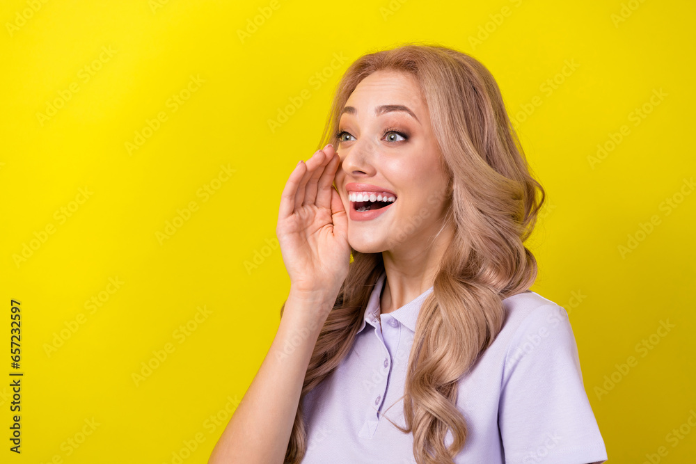 Photo of excited funky woman dressed violet t-shirt screaming secret empty space isolated yellow color background Photo of excited funky woman dressed violet t-shirt screaming secret empty space isolated yellow color background