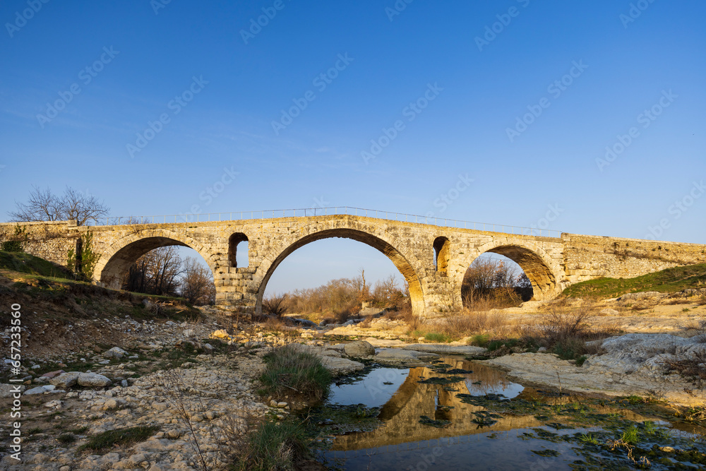 Pont Julien, roman stone arch bridge over Calavon river, Provence, France Pont Julien, roman stone arch bridge over Calavon river, Provence, France